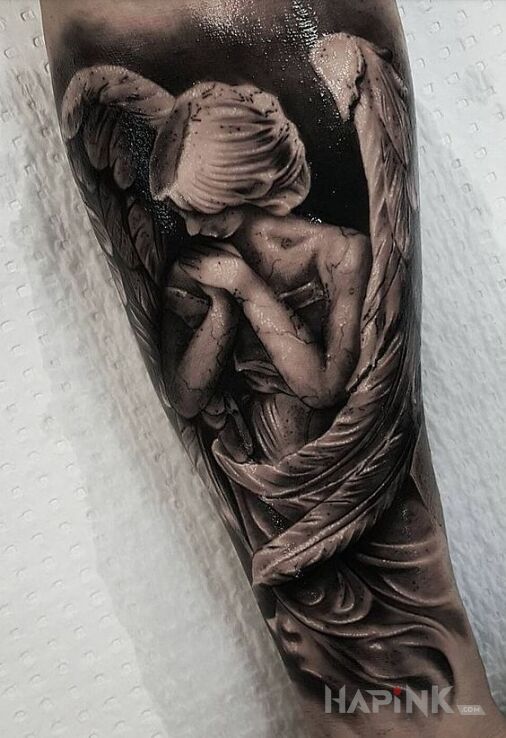 Tattoo Zawstydzony anioł in black and gray motif and realistic style on the forearm