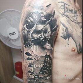 Tattoo Oswiecim on the upper arm motif: black and gray style: realistic