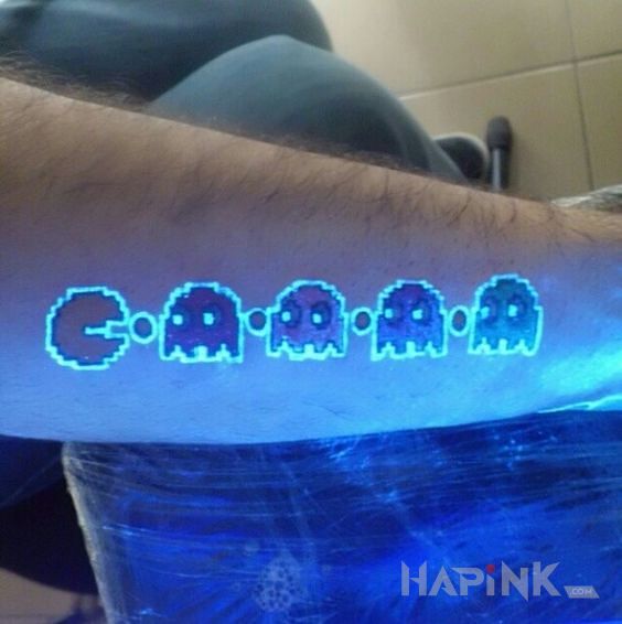 Tattoo Pac man in characters motif and graphic / illustrative style on the forearm