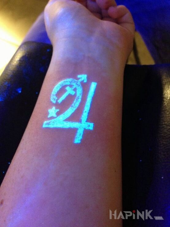 Tattoo Znak in glow in the dark motif on the forearm