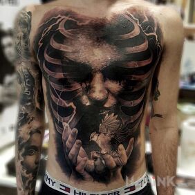 Tattoo A bird on the hand on the chest motif: characters