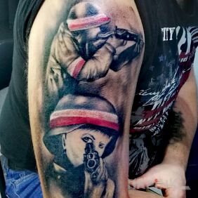 Tattoo Insurgent on the upper arm motif: war style: realistic