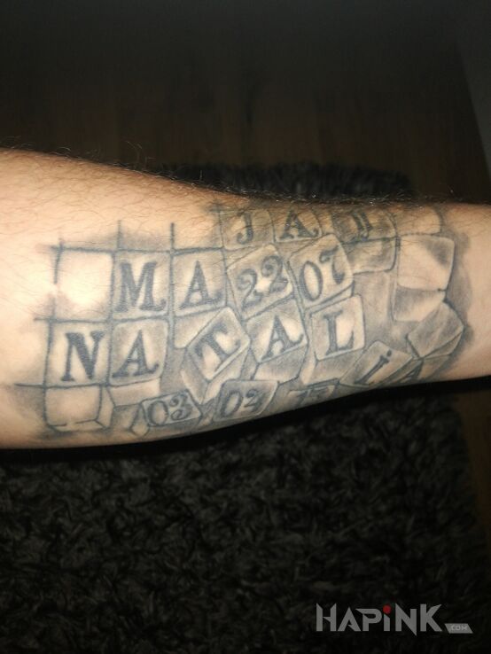 Tattoo Imiona i daty urodzin córek in objects motif and realistic style on the forearm