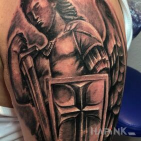 Tattoo Archangel on the upper arm motif: faces style: realistic