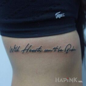 Tattoo Wild at Heart on the ribs motif: lettering style: calligraphy