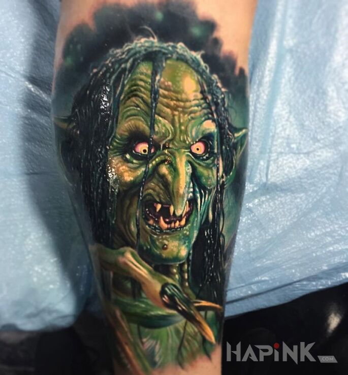 Tattoo Gremlin albo troll in characters motif on the forearm