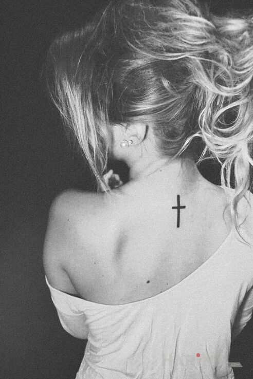 Tattoo Cross in religious motif and minimalistic style on the back