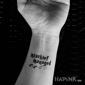 Tattoo Mischief managed on the forearm motif: lettering