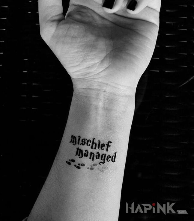 Tattoo Mischief managed in lettering motif on the forearm