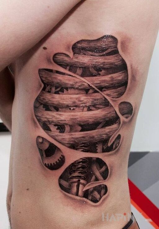Tattoo Pod skórą in ripped skin motif and realistic style on the ribs