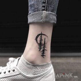 Tattoo Two Christmas trees near the ankle motif: black and gray style: graphic / illustrative