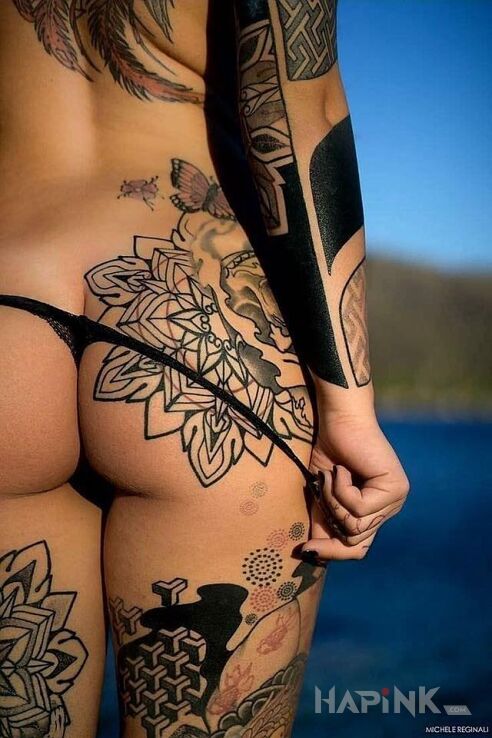 Tattoo Tył in sexy motif and blackwork / blackout style on the forearm