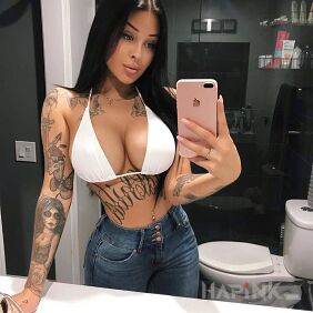 Tattoo Fota in the toilet on the upper arm motif: faces style: graphic / illustrative