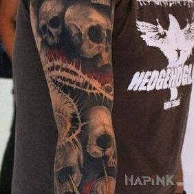 Tattoo Lots of skulls on the upper arm motif: skulls style: realistic