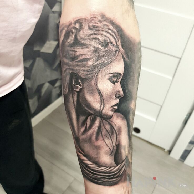 Tattoo Anioł in black and gray motif and realistic style on the forearm