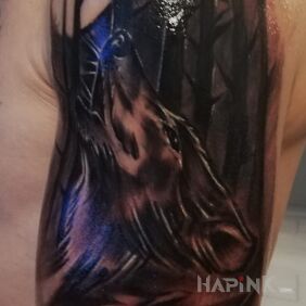 Tattoo Wolf on the upper arm motif: animals style: realistic