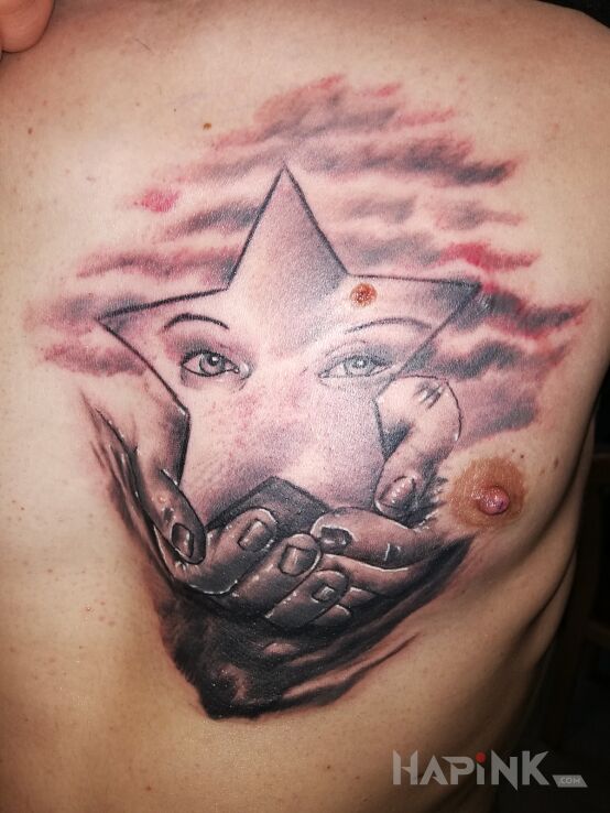 Tattoo Gwiazda in black and gray motif and realistic style on the chest