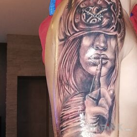 Tattoo Woman on the upper arm motif: black and gray style: realistic