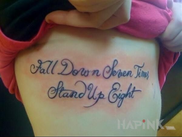 Tattoo Fall down seven times, stand up eight in lettering motif on the leg