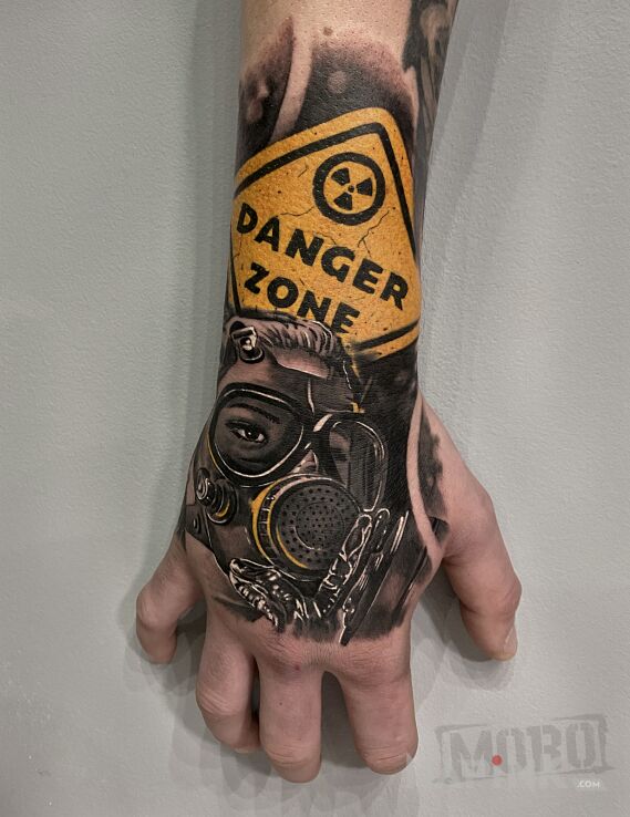 Tattoo Gas mask in colorful motif and realistic style on the hand