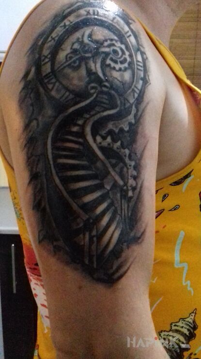 Tattoo Schody zegar in black and gray motif and realistic style on the upper arm