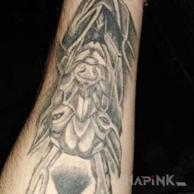 Tattoo A world of freedom on the forearm motif: black and gray style: graphic / illustrative