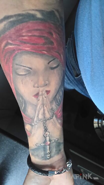 Tattoo Modlitwa in religious motif and realistic style on the forearm