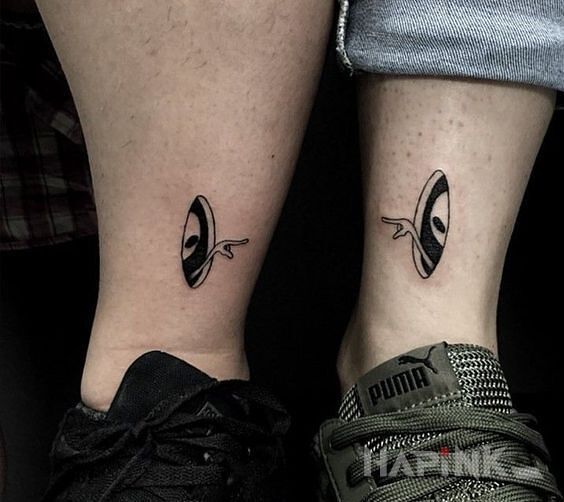 Tattoo Ufoludki in characters motif and minimalistic style on the leg