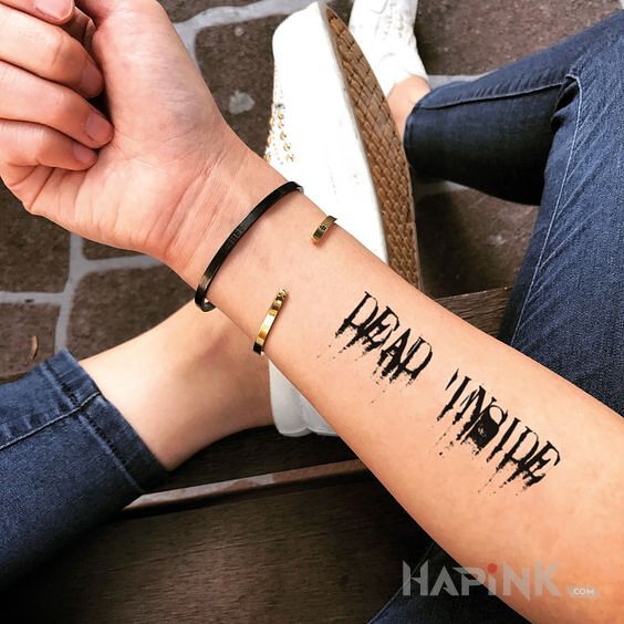 Tattoo Dead inside in lettering motif and calligraphy style on the forearm