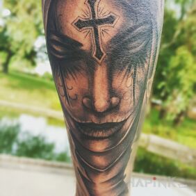 Tattoo Face with cross on the forearm motif: black and gray style: realistic