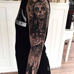 Tattoo Santa Muerte up his sleeve on the forearm motif: sleeves style: realistic
