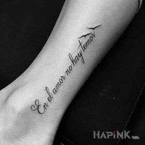 Tattoo In Spanish about love on the leg motif: lettering style: calligraphy