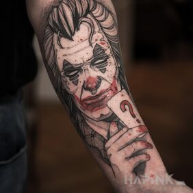 Tattoo Joker / Batman on the forearm motif: black and gray style: graphic / illustrative