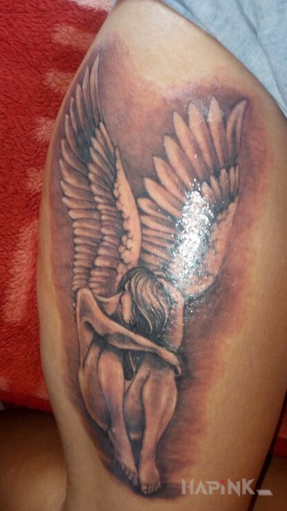 Tattoo Mój wymarzony anioł in black and gray motif and realistic style on the leg