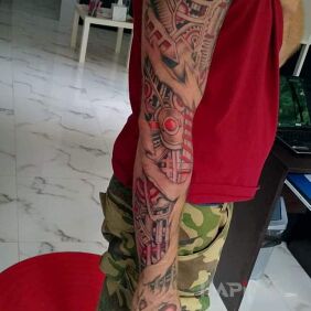 Tattoo Piti on the forearm motif: colorful style: biomechanics
