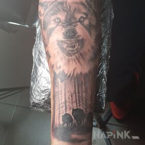 Tattoo Wolf on the forearm motif: black and gray style: realistic