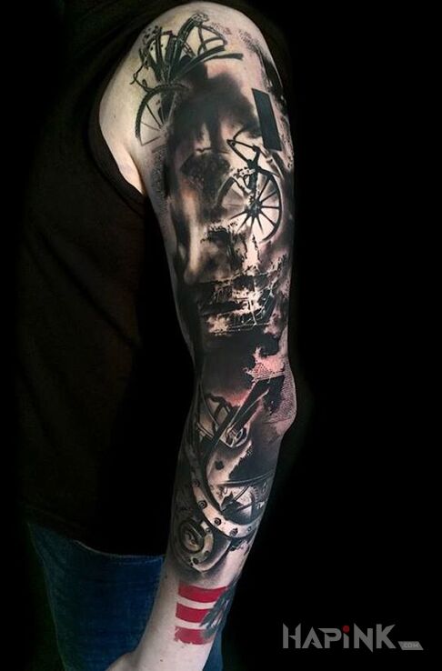 Tattoo Plamiasta trash polka in black and gray motif and trash polka style on the upper arm