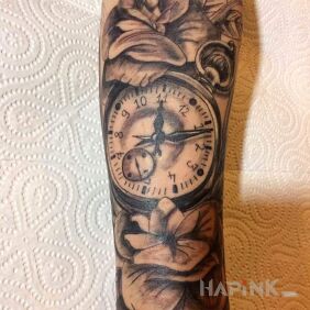 Tattoo The first one - a clock with flowers on the forearm motif: objects style: realistic