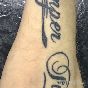 Tattoo SEMPER FIDELIS on the forearm motif: lettering style: calligraphy