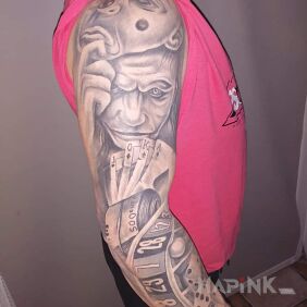 Tattoo Joker on the upper arm motif: black and gray style: realistic