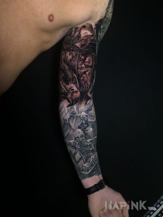 Tattoo Viking in war motif and realistic style on the upper arm