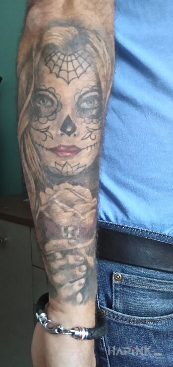 Tattoo Santa Muerte in santa muerte motif and realistic style on the forearm