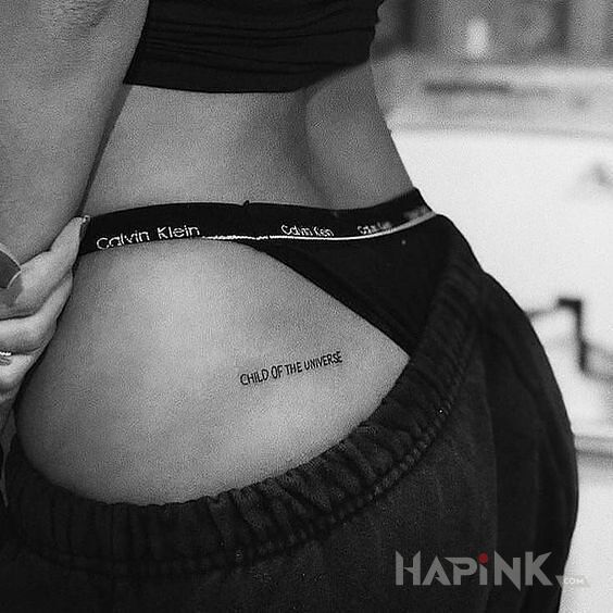 Tattoo Dziecko wszechświata in lettering motif and calligraphy style on the buttocks