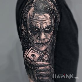 Tattoo Joker on the upper arm motif: black and gray style: realistic