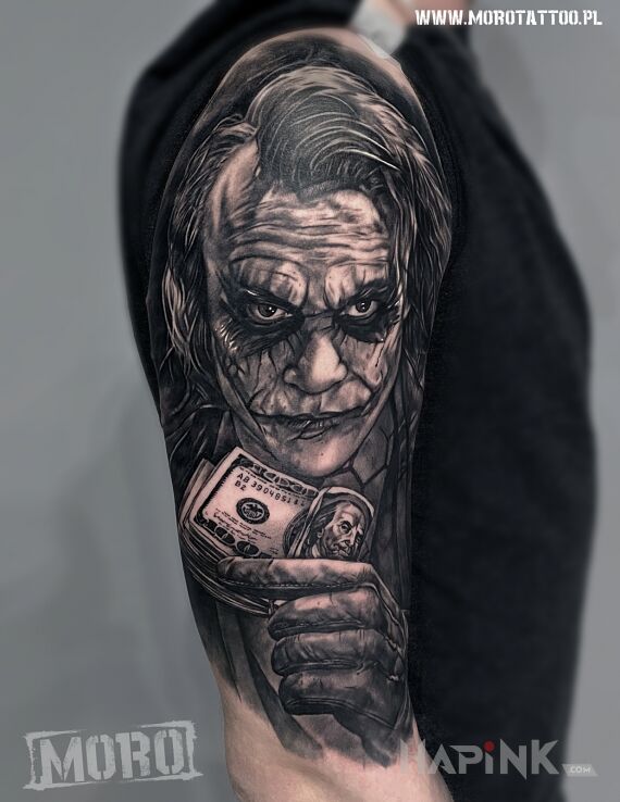 Tattoo Joker in black and gray motif and realistic style on the upper arm