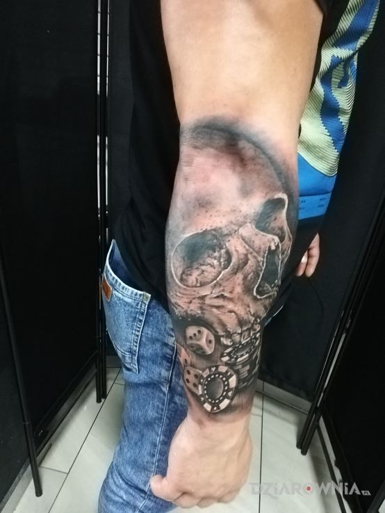 Tatuaż czaszka z żetonami do gry tattoo w motywie czarno-szare i stylu realistyczne na przedramieniu