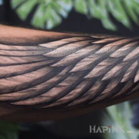 Tattoo Wing on the forearm motif: black and gray style: graphic / illustrative