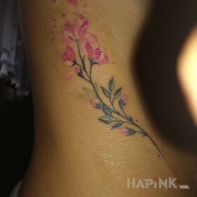 Tattoo Pastel flower on the ribs motif: colorful style: realistic