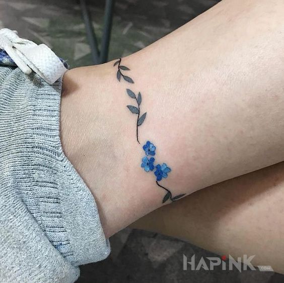 Tattoo 3 niebieskie kwiaty in flowers motif and minimalistic style near the ankle