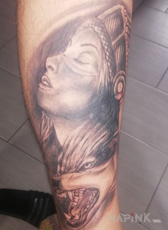 Tattoo Indianka z wilkiem in Indian motif and realistic style on the calf
